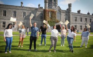 Eight participants holding certificates outside NUI Galway’s Quadrangle building.